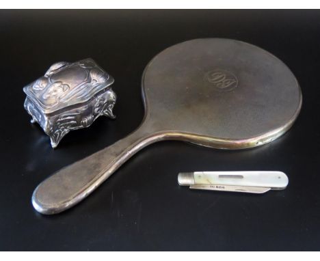 A Silver backed hand mirror, initialled, a silver bladed folding fruit knife with mother-of-pearl handle and an Art Nouveau m