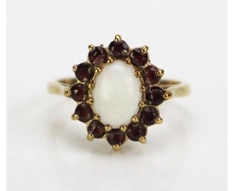 A 9ct Gold, Opal and Garnet Cluster Ring, hallmarked, 14x12.5mm head, 8x6mm singlet opal, size J, 2.53g 