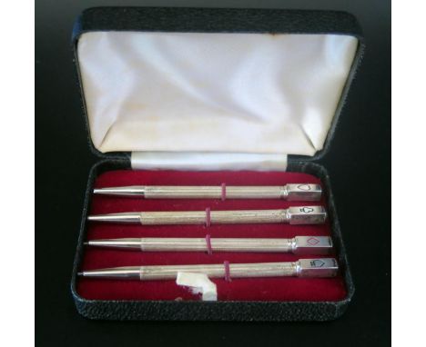 A set of four Elizabeth II silver propelling bridge pencils, maker William Manton, Birmingham, 1982, with engine turned decor