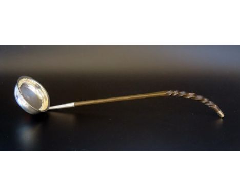 A Georgian silver toddy ladle, maker WM, of oval outline, with baleen spiral twist handle, 33cm long. 