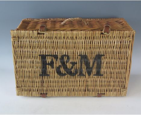 A Fortnum &amp; Mason wicker hamper, with leather hinges, stencilled F &amp; M to the hinged lid, 50cm wide. 