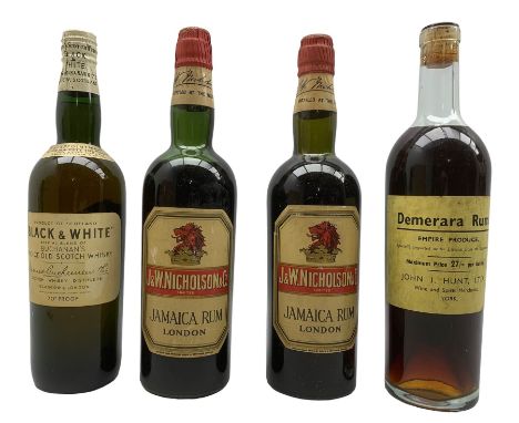 Bottle of Demerara Rum, Empire Produce, with the label of John Hunt, York, bottle of Black &amp; White Scotch Whisky and two 