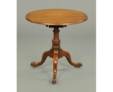 A George III mahogany tripod table, with snap bird cage action, turned column and three downswept legs terminating in pad fee