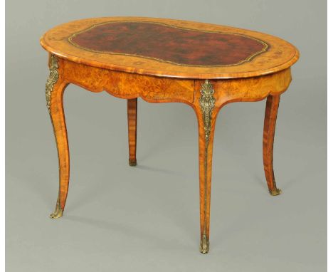 A Victorian walnut marquetry oval writing or centre table, with red gilt tooled leather centre surface, floral marquetry surr