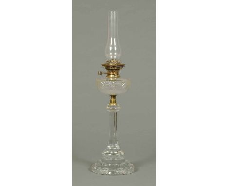 A 19th century cut glass oil lamp, with reservoir and faceted base.  Height including chimney 30 ins.