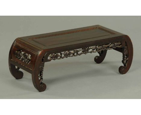 A Chinese hardwood low occasional table, with pierced frieze and scroll legs.  Width 32 ins.  CONDITION REPORT: The table is 