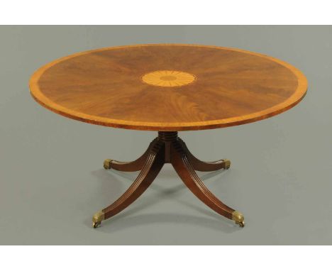 A George III style mahogany breakfast table, with inlaid centre medallion and satinwood edge, raised on a centre turned colum