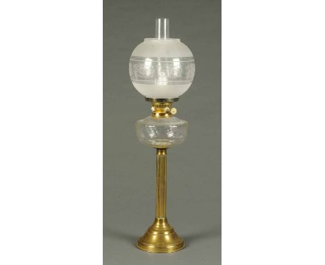 A Victorian brass oil lamp, with glass reservoir and etched glass shade, converted to electricity.  