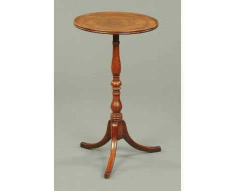 A 19th century mahogany tripod table, the circular top with moulded edge supported by a turned column with three downswept le