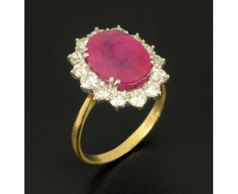 An 18 ct ruby and diamond cluster ring, with yellow gold shank, ruby 6.16 carats, diamonds .78 carats, size O/P (see illustra