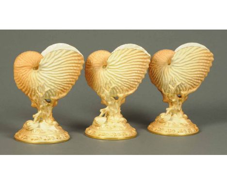 Three Royal Worcester Nautilus shell vases, each with puce marks.  Height 8 ins (see illustration).
 