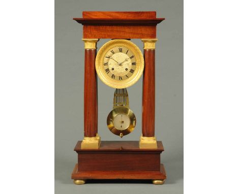 A late 19th century French mahogany portico clock, in the Empire style, with 5.75 inch circular dial and two-train striking m