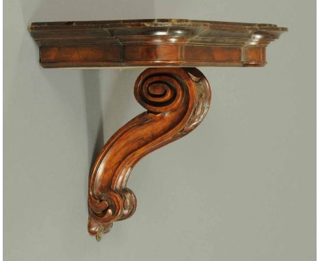 A Regency walnut clock bracket, with single scroll support.  Width 19 ins.  CONDITION REPORT: The clock bracket is in general
