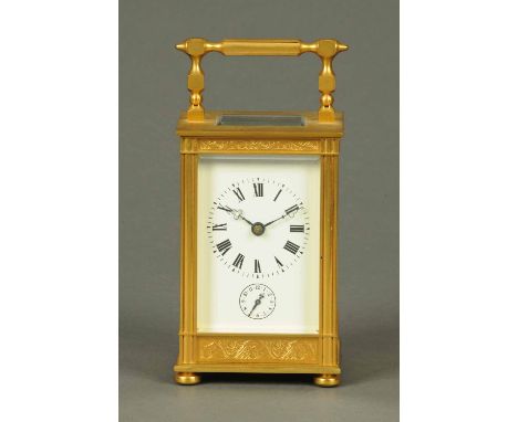 An Edwardian brass carriage clock, with alarm mechanism, of large form.  Height excluding carrying handle 15 cm (see illustra