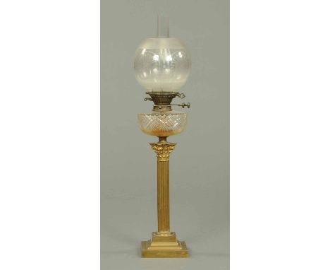 A Victorian oil lamp, with etched glass shade, cut glass reservoir and Corinthian capital to brass column.  Height 31 ins. 