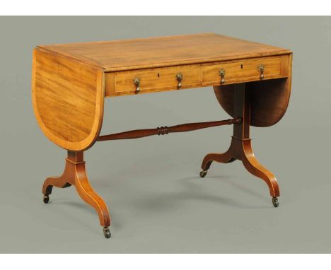 A Georgian mahogany sofa table, crossbanded and with moulded edge, fitted with two frieze drawers and raised on four downswep