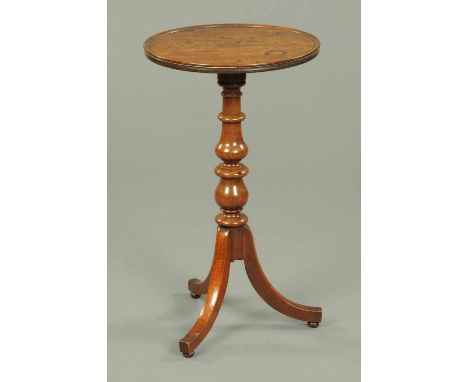 A George III mahogany tripod table, with circular dished top, moulded edge, centre turned column and raised on three downswep
