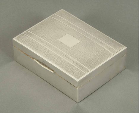 A silver table cigarette box, engine turned, Birmingham 1947.  Length 4.5 ins. CONDITION REPORT: Generally very good order wi