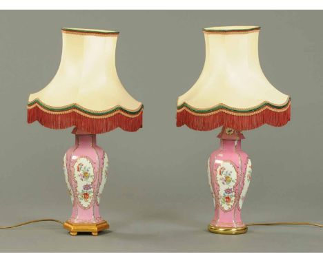 A pair of porcelain table lamps, polychrome, one with wooden base, one ceramic.