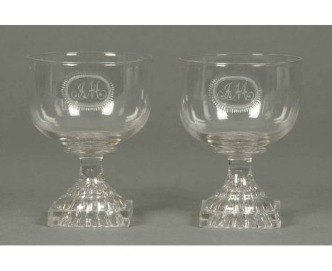 A pair of Regency glass goblets, with lemon squeezer bases, initialled JM.  Height 5 ins (see illustration).
 