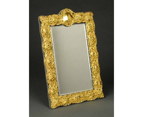 A Victorian silver gilt framed mirror, Birmingham 1899, easel back.  Height 15 ins, width 10 ins (see illustration).
  CONDIT
