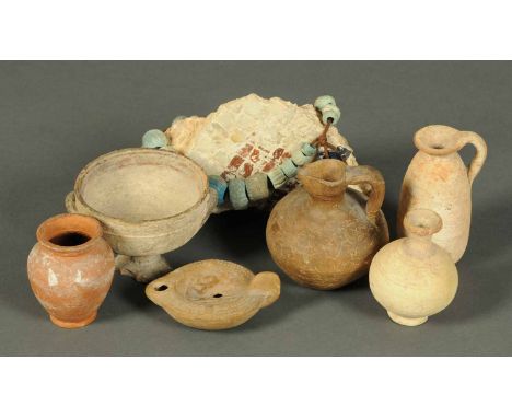 A collection of seven terracotta antiquities, Roman oil lamp, two jugs, three vases and part mosaic flooring.  