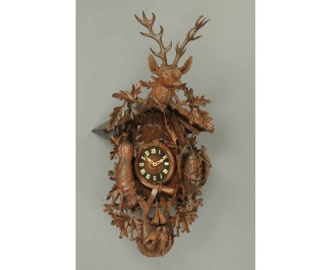 A massive Black Forest cuckoo clock, wall mounting, playing four tunes, one on the hour and one of the half hour, in well car