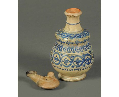 A terracotta Roman oil lamp, and a Persian pottery vase.  