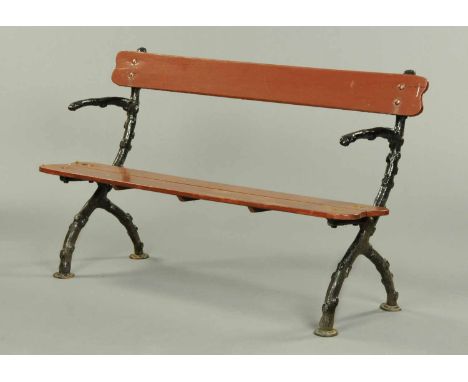 A Victorian garden bench, with cast iron branch form ends and planked seat and back.  
