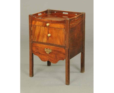 A George III mahogany commode, of tray top type, fitted with a frieze drawer, cupboard and pullout commode.  Width 22 ins.  C