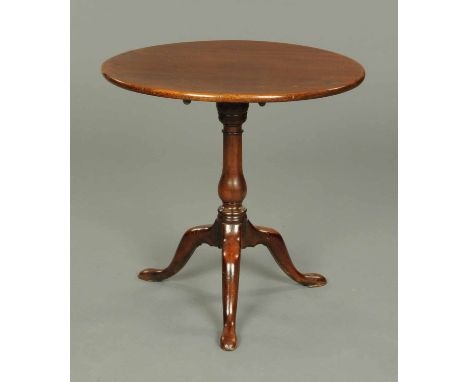 A George III mahogany tripod table, with snap action, turned column and three downswept legs terminating in pad feet.  Diamet