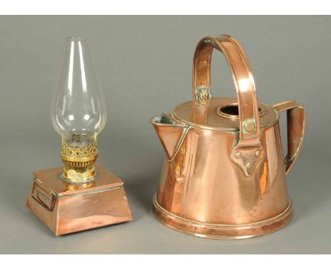 A 19th century copper watering can, with loop handle and sparrow beak and an oil lamp with copper reservoir and clear glass s