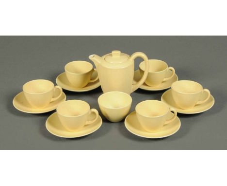A Poole Pottery coffee service, pastel yellow, comprising six cups, saucers, sugar basin and coffee pot.  