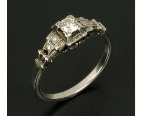 An 18 ct white gold Art Deco diamond ring, size K, with central diamond and diamond set shoulders, stamped "18 k". CONDITION 