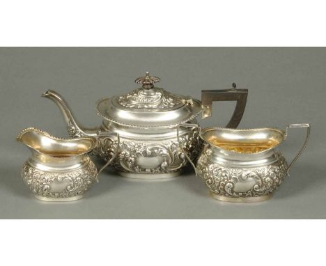 An Edwardian three piece silver tea service, foliate embossed, Birmingham 1906, 602 grams (see illustration).
 