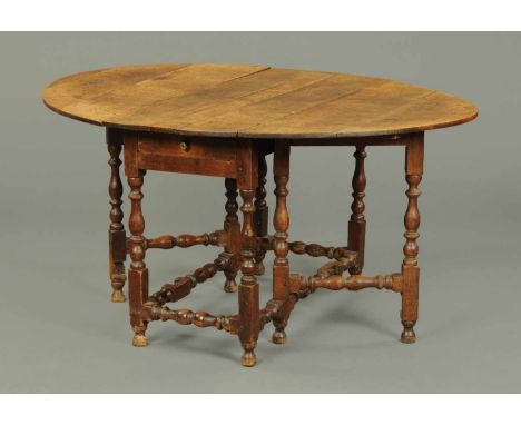 A 19th century oak gate legged table, with turned supports and stretchers.  Width 47 ins, length 57 ins. 