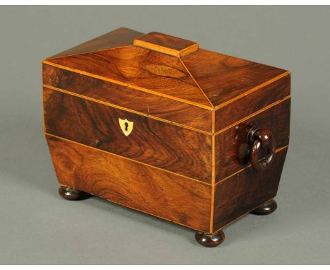 A Regency rosewood tea caddy, boxwood strung and raised on four short bun feet.  Width 7.5 ins (see illustration).
 