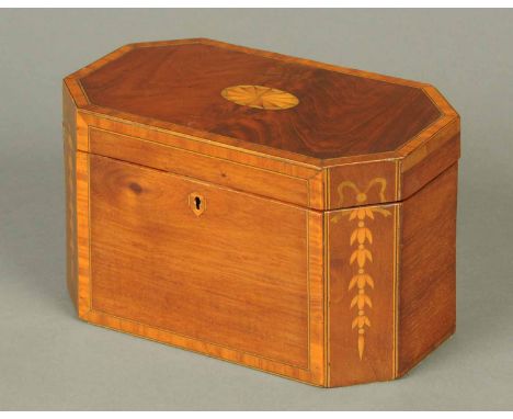 A George III mahogany tea caddy, inlaid and with canted angles.  Length 24 cm (see illustration).
 