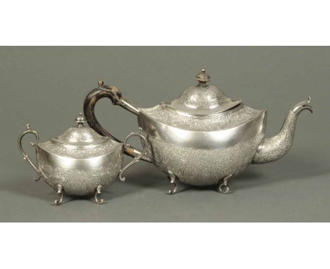 An Indo Chinese, possibly Malayan, teapot and lidded sucrier, foliate and scroll engraved, 1029 grams, late 19th/early 20th c