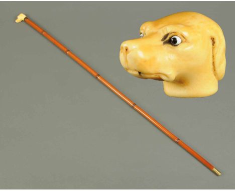 A Victorian sword stick, with carved ivory dog head to the handle.  Head length 4 cm, cane height 85 cm (see illustration). 