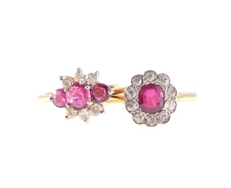 Two ruby and diamond rings, a single ruby surrounded by ten old cut diamonds and milgrain set in a yellow and white metal cus