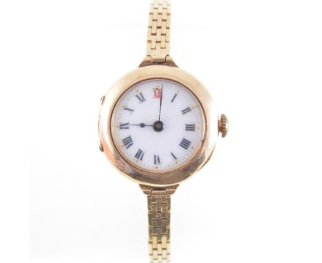 A lady's vintage wrist watch, the 16mm white enamel dial with roman numeral chapter ring in a 15 carat yellow gold case, 5 je
