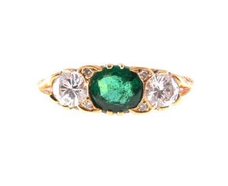 An emerald and diamond half hoop ring, one oval faceted emerald, two brilliant cut diamonds, claw set in an 18 carat all yell