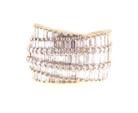 A modern baguette cut diamond dress ring, seventy tapered baguette cut stones pave set in five rows to an all yellow metal mo