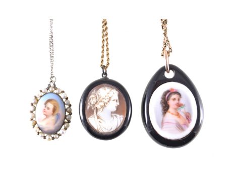A cameo pendant and two portraits, an oval carved shell cameo  in a black jet style pendant 40mm x 33mm, on a yellow metal so