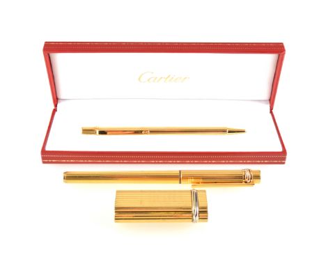 Must de Cartier - a ball point pen boxed, fountain pen and Cartier cigarette lighter, all gold-plated with a polished vertica