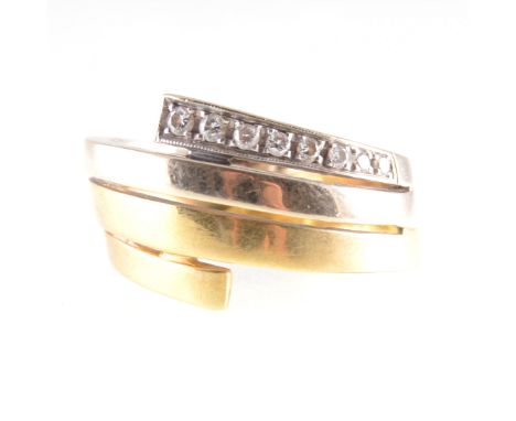 A diamond set dress ring, a yellow and white metal four band mount set with eight brilliant cut diamonds graduating in size, 