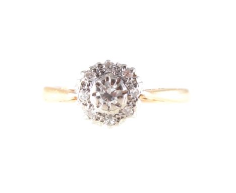 A diamond cluster ring, a central brilliant cut diamond surrounded by eight smaller eight cut diamonds in an 18 carat yellow 