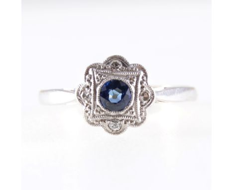 A circular sapphire and diamond cluster ring, a round brillaint cut sapphire and four 8 cut diamonds milgrain set in yellow a