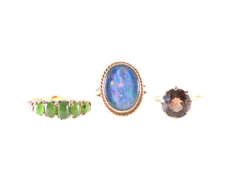 Three gemset dress rings, an oval cabochon cut opal triplet 15mm x 12mm collet set in a 9 carat yellow gold mount with twiste